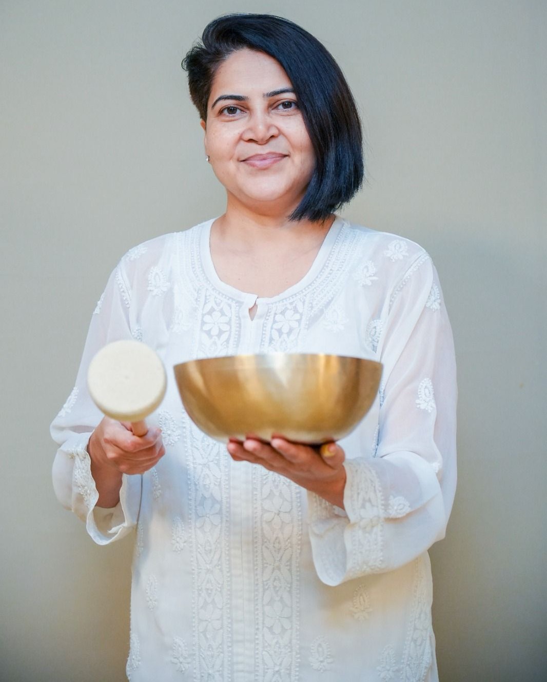 Vaishali Maa holding a singing bowl
